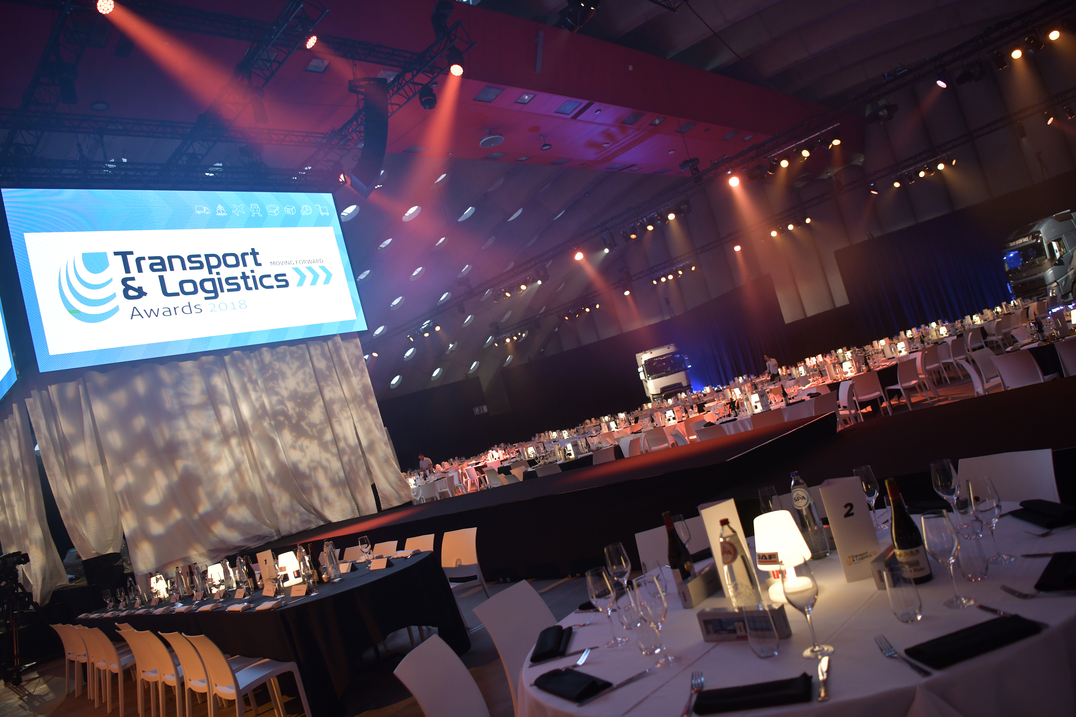 featured-article (1).jpg event location with round tables and a stage but no people