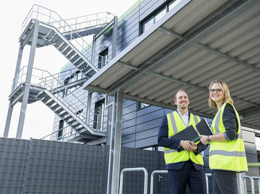 Two property managers stand outside a property in Duesseldorf