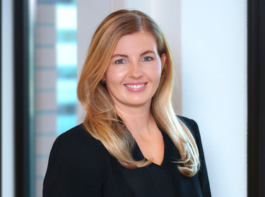 Gina Helmond standing in an office
