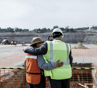 Two employees congratulate each other at a groundbreaking in Mexico City